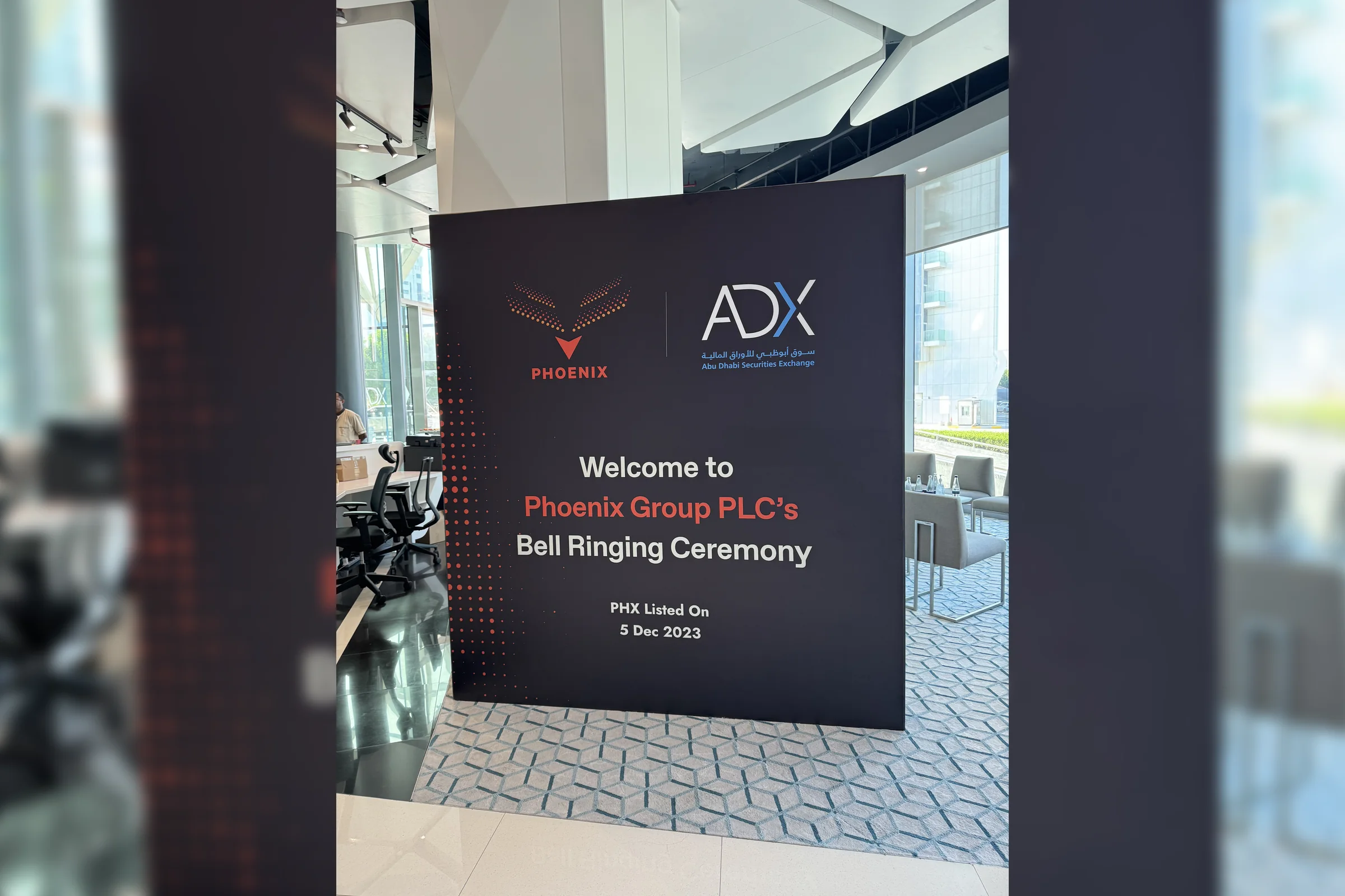 Signage at the Abu Dhabi Securities Exchange welcoming the Phoenix Group PLC bell ringing ceremony, PHX listed on 5 December 2023